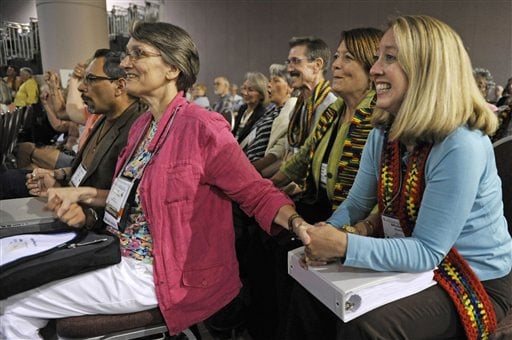 Mulheres sorriem diante da aprovação da ordenação de gays e lésbicas na PCUSA. (AP Images/Jim Mone)