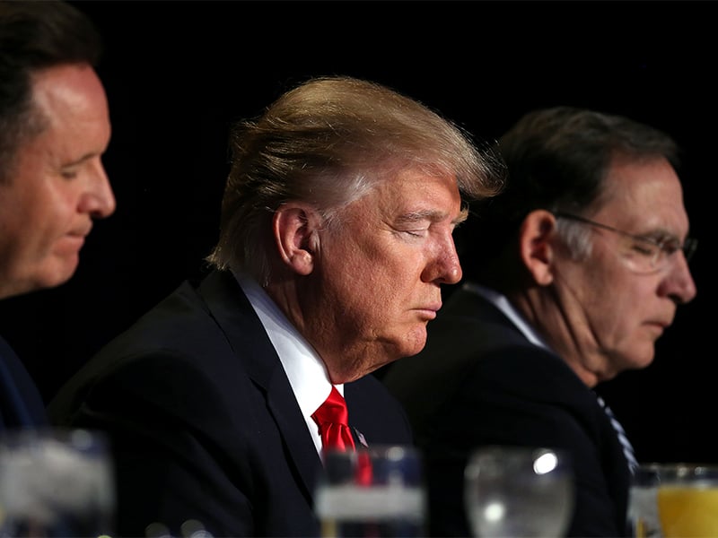 Presidente Donald Trump ora durante evento National Prayer Breakfast, em Washington. (Foto: Reuters/Carlos Barria)