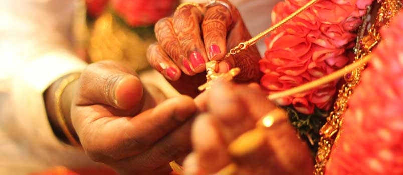 Casal hindu segura pingente nas mãos. (Foto: Marriage.com)